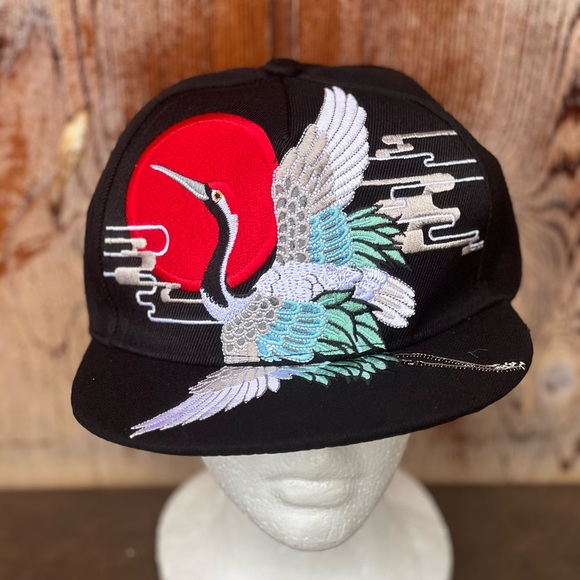 Embroidered crane snap back trucker hat